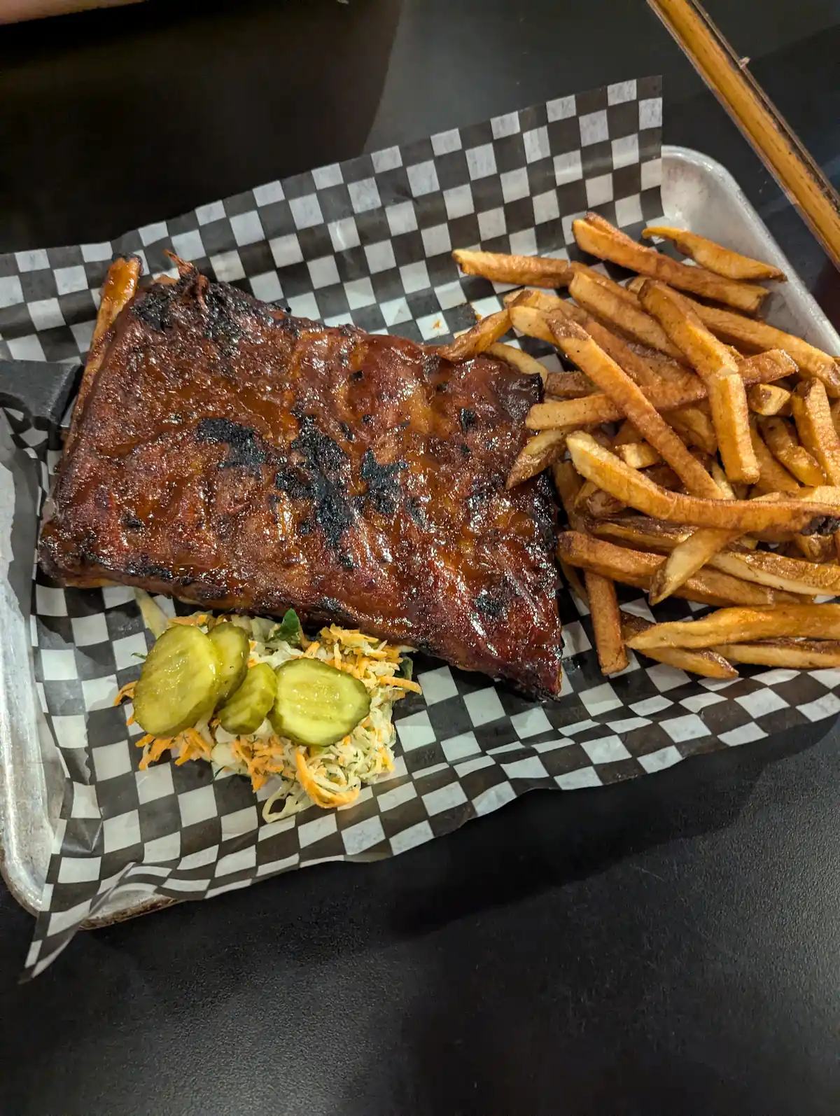 ribs with a side of fries and coleslaw from beyond the pale